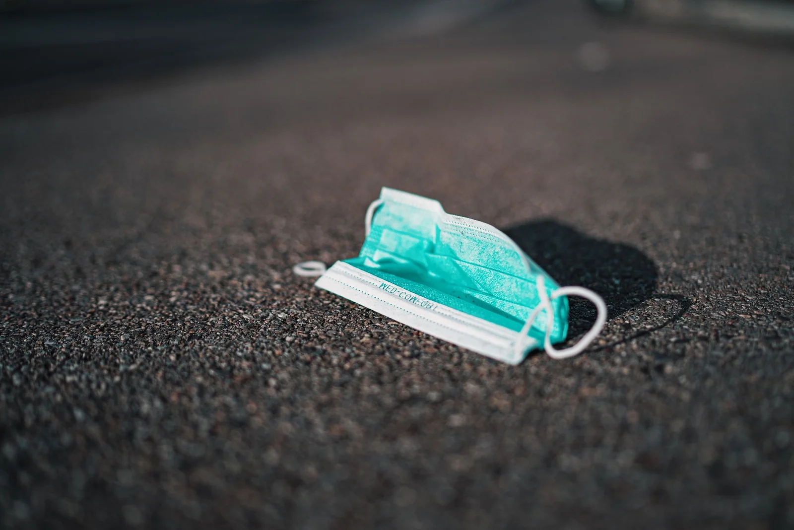 The discarded mask symbolizes the necessity of the remask project